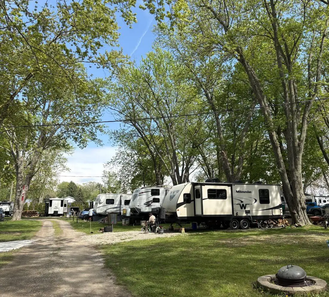 Shaded campsites on the grounds of Erie Shores Cottage Community